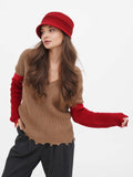 Full-length view of red cloche hat with camel sweater and black pants