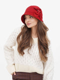 Close-up of red wool cloche hat with side bow and warm lining