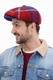 Side angle man wearing red blue plaid newsboy cap with shearling collar denim jacket