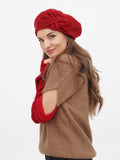 Red wool women's beret with flower embellishment side profile close-up showing petal structure