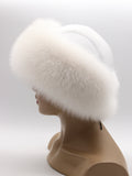 Right side of round white fox fur hat from behind, leather top just visible