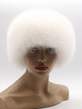 Front view of round white fur hat with a full arctic fox band framing the face
