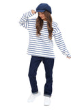 Angled full body view woman in royal blue wool baker boy hat blue trousers