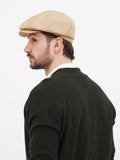 Side profile sand beige linen newsboy cap showing soft straight visor