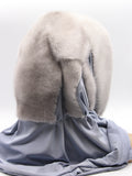 Three-quarter back view sapphire mink fur hat hood with blue-grey jersey shawl draped across shoulders