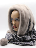 Three-quarter view sapphire mink fur hat hood showing cool grey mink surface and blue gradient leopard scarf
