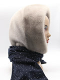 Front angled view sapphire mink hood scarf showing light mink crown against dark dotted scarf body