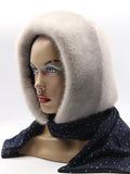 Three-quarter view sapphire mink hood showing blue-grey mink surface transitioning to dark dotted scarf