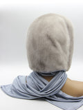 Back view sapphire mink fur hood on mannequin showing full mink coverage and blue-grey fabric scarf