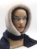 Sapphire mink fur hood with dark dotted fabric scarf on mannequin, front view showing light-dark contrast