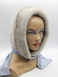 Sapphire mink fur hood scarf minimalist design on mannequin, front three-quarter view showing clean mink face opening and fabric scarf