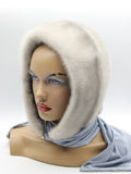 Three-quarter view sapphire mink hood scarf on mannequin showing smooth mink surface and fabric scarf drape