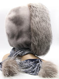 Sapphire mink fur hood wrap on mannequin three-quarter back view with silver fox pompon visible