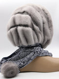 Close view sapphire mink suede striped fur hat hood showing texture contrast between mink pile strips and flat suede bands