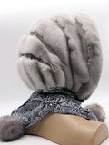Three-quarter back view sapphire mink suede striped fur hat hood with scarf ties and sapphire mink pompons