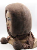 Back view tobacco brown dyed mink fur hood on mannequin showing full mink coverage and warm fabric scarf tail