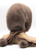 Front angled view tobacco brown mink hood on mannequin showing warm brown tone against coordinated fabric