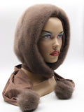 Tobacco brown dyed mink fur hood scarf with matching mink pompons on mannequin, front three-quarter view