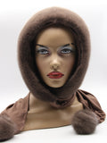 Three-quarter view tobacco brown mink hood showing warm dyed mink pile and coordinated fabric scarf