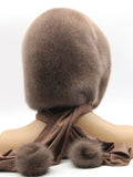 Three-quarter back view tobacco brown mink fur hood scarf with mink pompon visible at scarf end