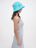 Side profile of turquoise cotton bucket cloche hat showing brim shape