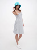Front view of woman in turquoise sun hat and striped summer dress