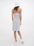 Back view of woman in white bucket hat and striped summer dress