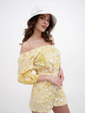 Full-length view of white bucket hat with yellow floral dress