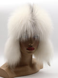 White fur trapper hat framing the face, fox ear flaps falling past the chin