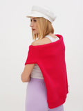 Side view of white linen Breton cap with woman wearing red wrap top