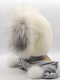 White mink fur hood scarf wrap with arctic fox face trim and large pompons, side view on mannequin