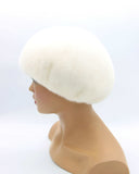 White mink beret high crown three-quarter left view showing dense fur pile and volume dome height
