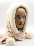 White mink fur hat hood front view on mannequin showing pure white mink and light beige fabric scarf