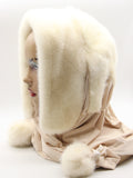 Side profile white mink fur hat hood with beige scarf showing white mink pompons distributed along scarf