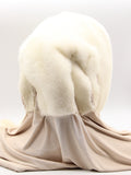 Three-quarter back view white mink fur hat hood with beige scarf showing three white mink pompons along scarf length