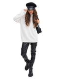 Woman in black Breton cap and street style outfit front view