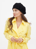 Women's black French beret with flower three-quarter front view showing flat crown and wool texture