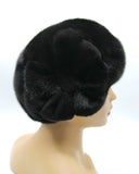 Women's black mink fur beret with applique flower front view showing dense natural black mink texture and flower detail