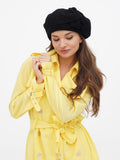 Women's black wool beret back view showing flat crown drape over long hair, autumn styling