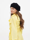 Women's black wool beret with handcrafted fabric flower side profile view showing tonal flower detail on left crown