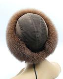 Rear view of women’s brown fur hat with suede panels and drawstring at the nape