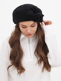 Women's dark grey wool beret back view showing flat crown drape and long hair compatibility