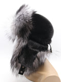 Side profile of women’s fox fur hat showing smooth black mink crown and hanging flaps