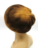 Women's golden brown mink fur beret back view showing full crown and rare natural amber-brown mink color