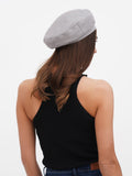 Women's grey linen beret back view showing flat crown shape and long hair with beret
