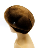 Women's mink fur beret pastel brown three-quarter right view showing dome construction and fur texture
