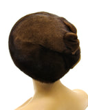 Women's pastel brown mink beret lower angle view showing crown base construction and adjustable fit