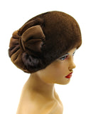 Women's pastel brown mink fur beret with handcrafted mink flower side profile view showing soft caramel-brown fur and flower detail