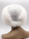 Back view of women’s white fur hat showing panel-stitched white leather crown