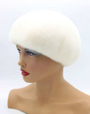 Women's white mink fur beret high volume crown side profile view showing luminous white fur and sculptural dome silhouette